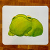 A caricature illustration of a green frog on a mousepad.