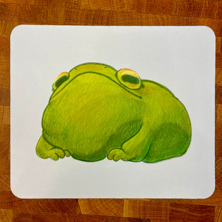 A caricature illustration of a green frog on a mousepad.