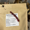 Red millipede, or Fire Millipede, on a label with feeding suggestions on a brown paper food bag.