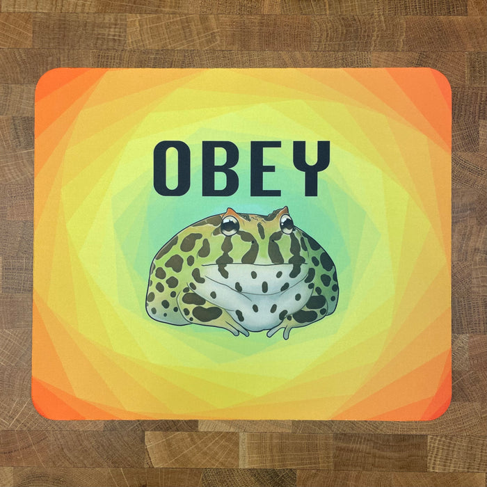 Colorful mousepad with a pacman frog design and the text 'OBEY' on a multicolored background.