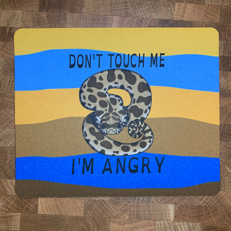 A mousepad decorated with an illustration of an angry hognose snake with the words Don't Touch Me printed on it.